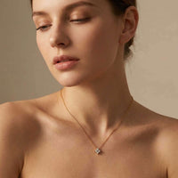 Thumbnail for Crystal Flower necklace worn by model, signature four-leaf zircon pendant catching light with diamond-like brilliance
