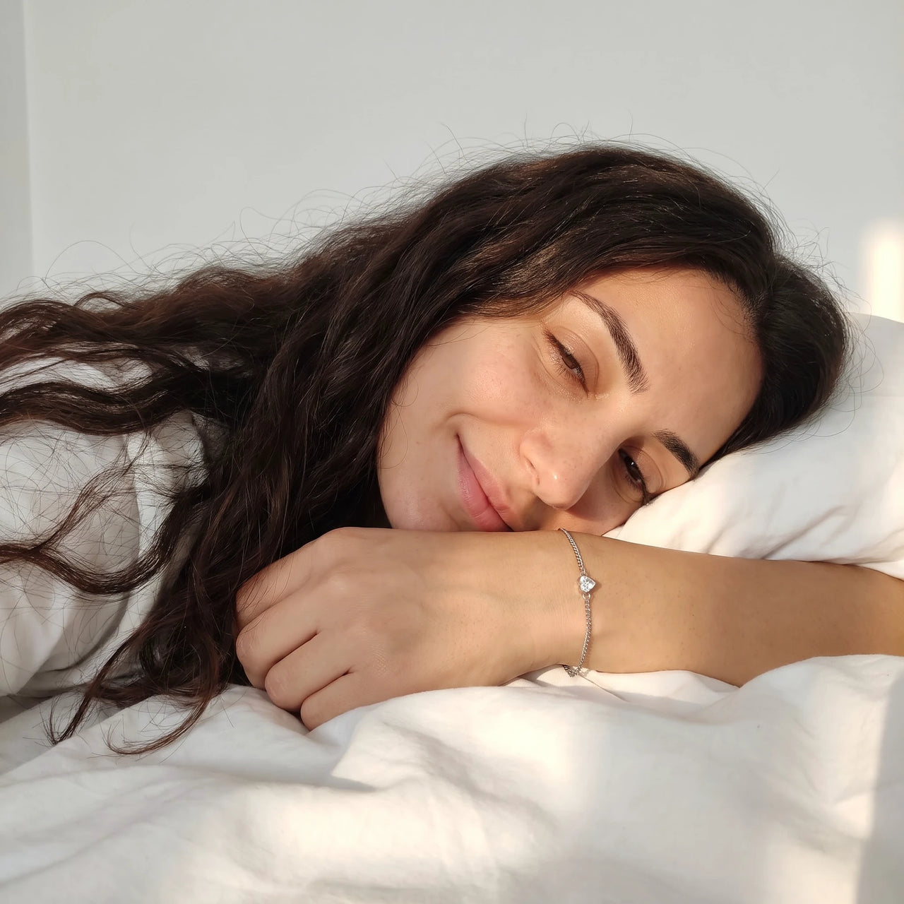 Heart Bond Matching Bracelet Set in Silver — worn on her wrist on a lazy morning in bed