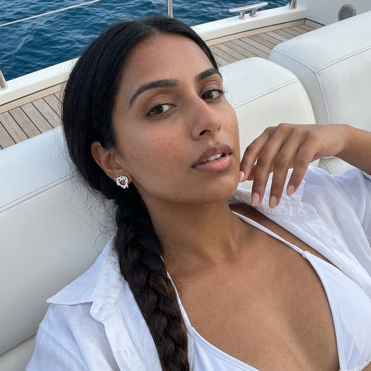 Woman on a yacht wearing the silver stud earrings | SKU: 4478648-platinum-plated-clear