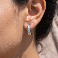 Thumbnail for Close-up of the silver huggie hoop earrings worn on the skin | SKU: 22023999-rhodium