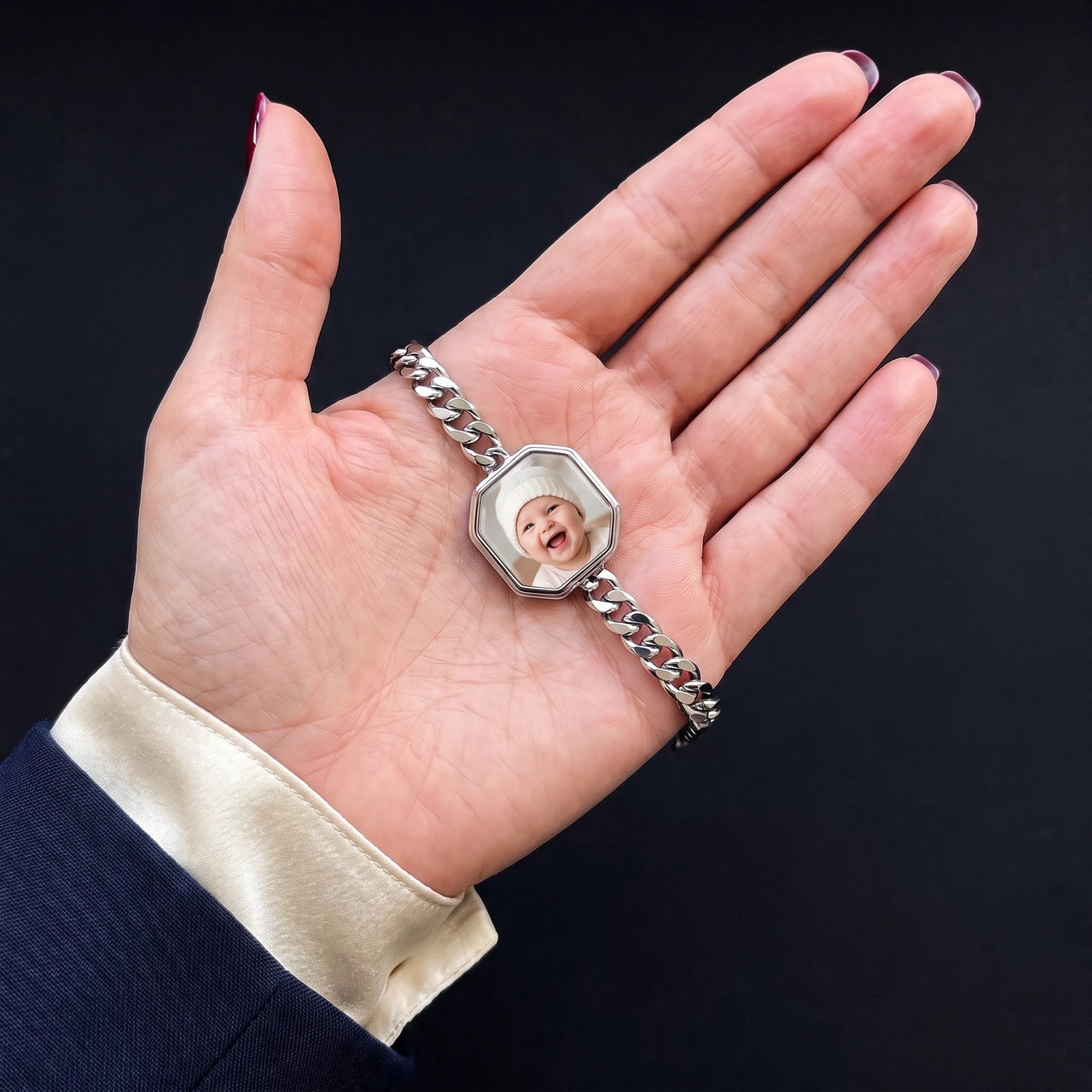 Thumb warming the silver octagon bracelet plate: the hidden photo appears under the thumb while the rest stays black | SKU: TPH-OCTB-SILVER-18