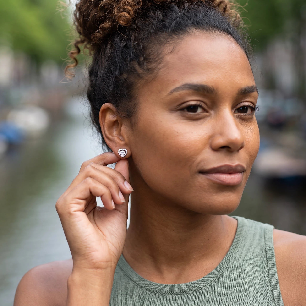 Woman gently touching her silver stud earrings | SKU: 1953493